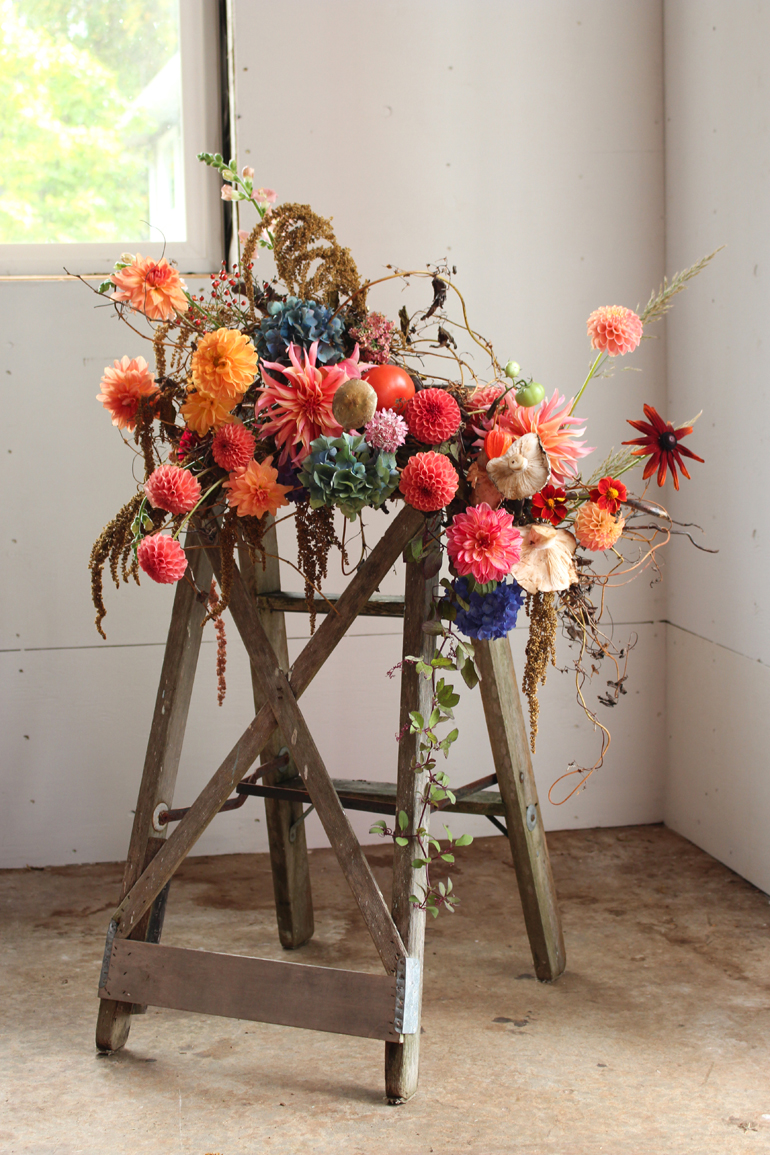 Fall floral installation with dahlias and foraged mushrooms